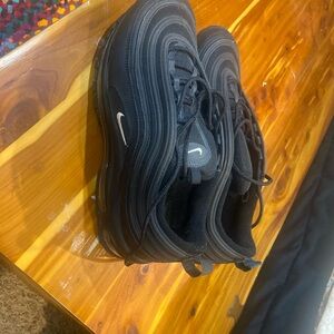 Nike Black Sneakers with Distinctive Wavy Design and Thick Rubber Sole